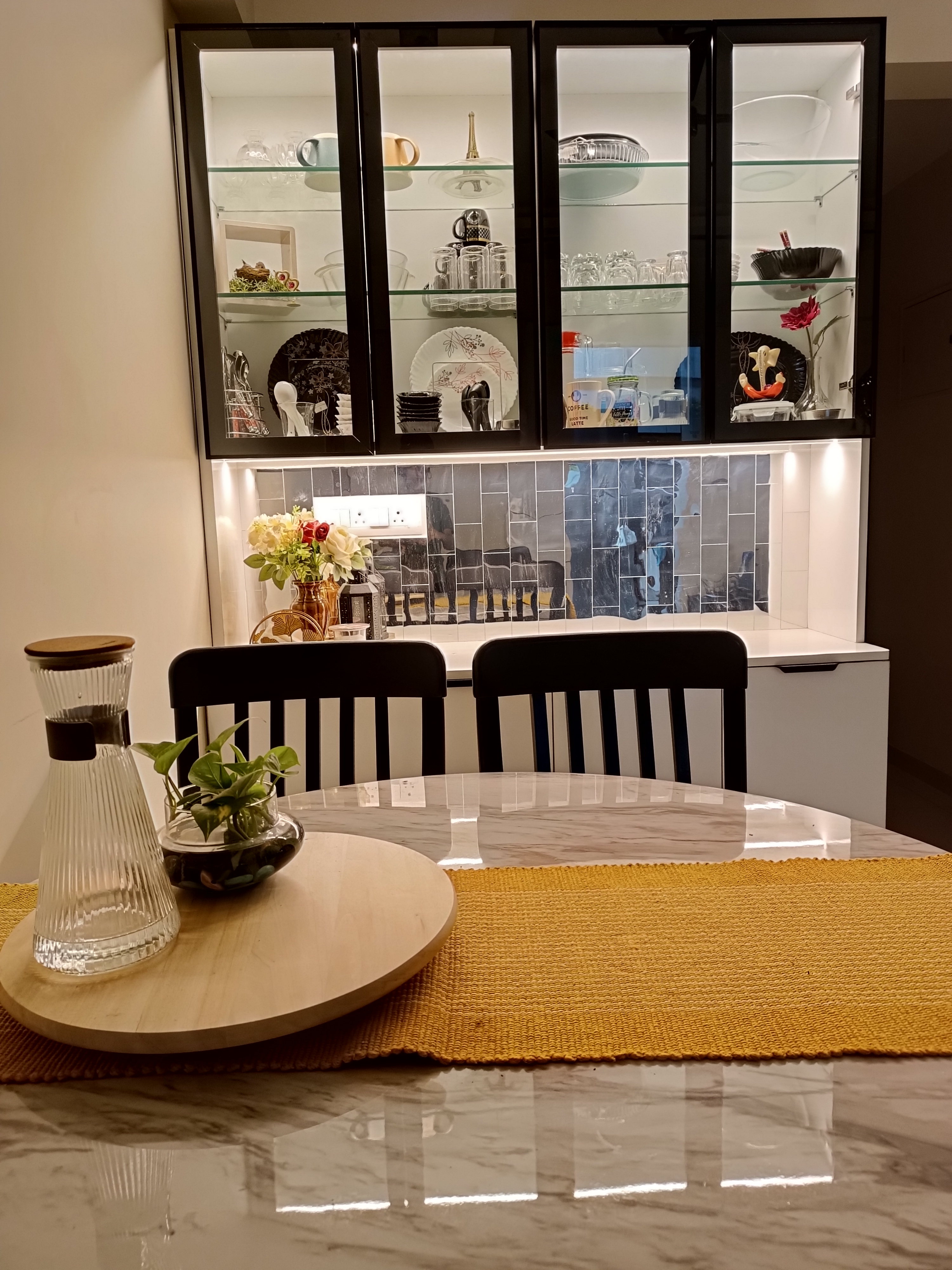 Crockery unit with glass display and warm lighting